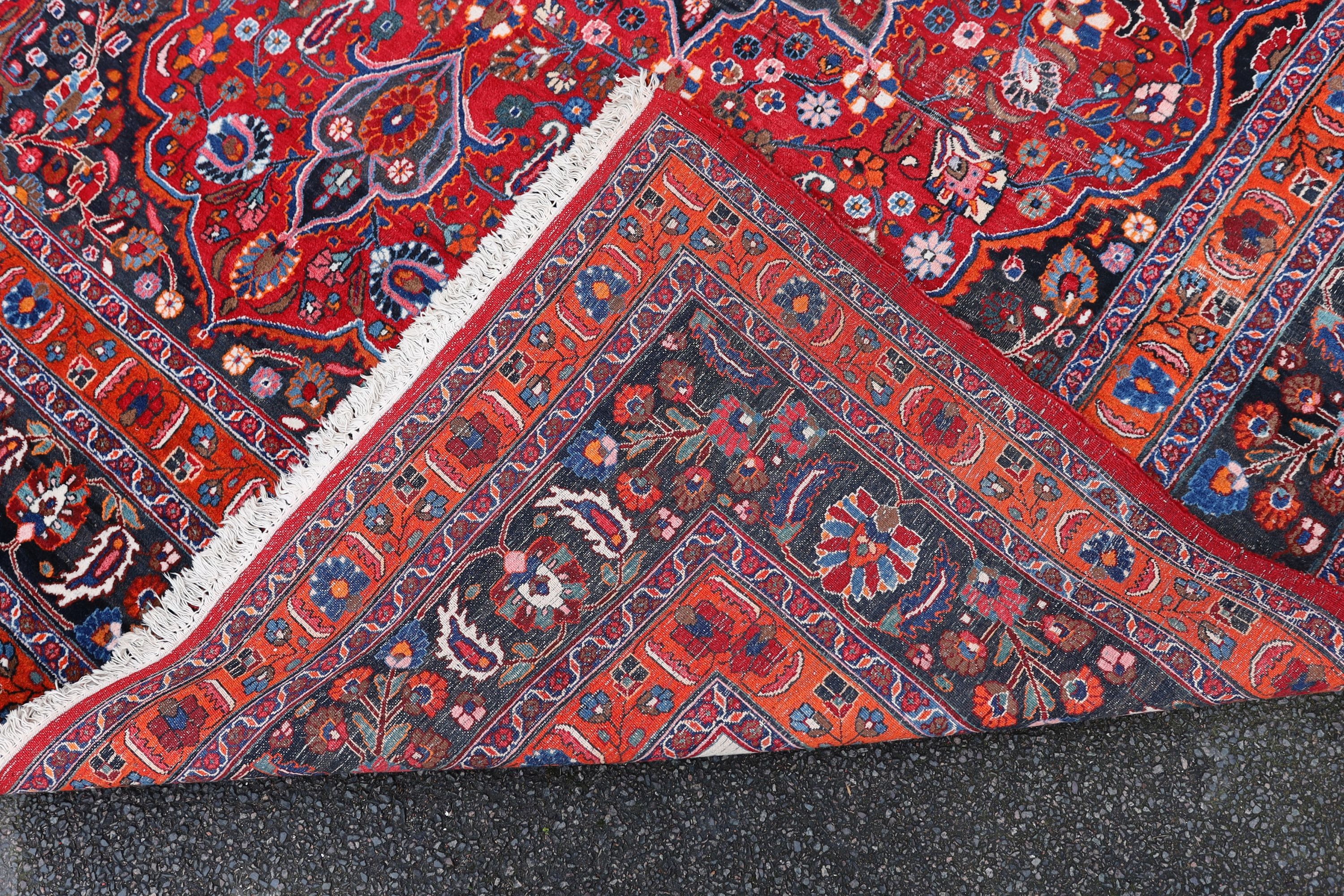 A Tabriz red ground carpet 422 x 326cm.